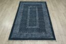Indigo block print cotton area rug with fringe, full view on wood floor