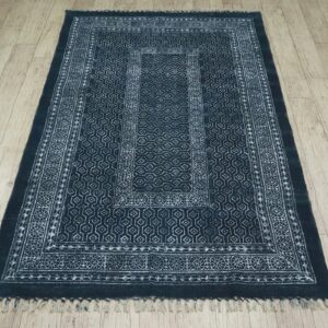 Indigo block print cotton area rug with fringe, full view on wood floor