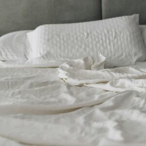 White washed cotton sheet set on a bed with pillowcase